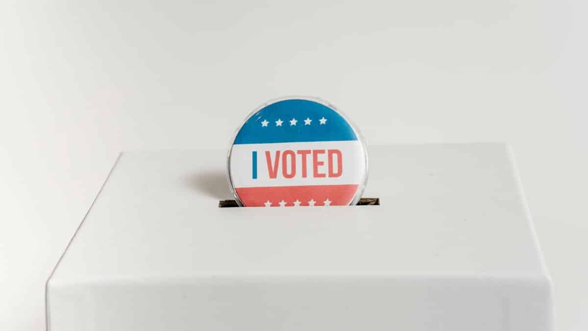 Close-up of an I Voted badge on a ballot box, symbolizing voting in the USA elections.