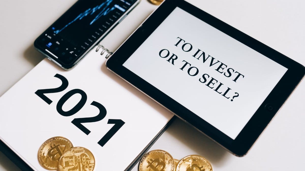 Bitcoin and investment strategy visualized with smartphone, tablet, and coins.