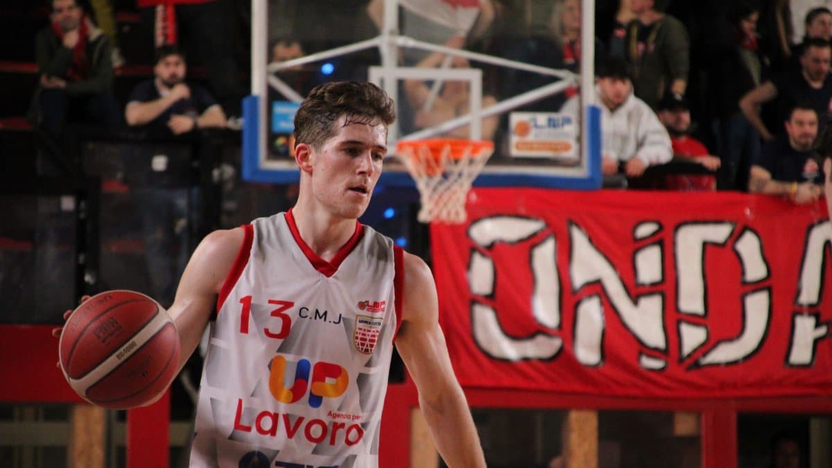 Action-packed basketball game captured in Imola, showcasing a focused player mid-game.