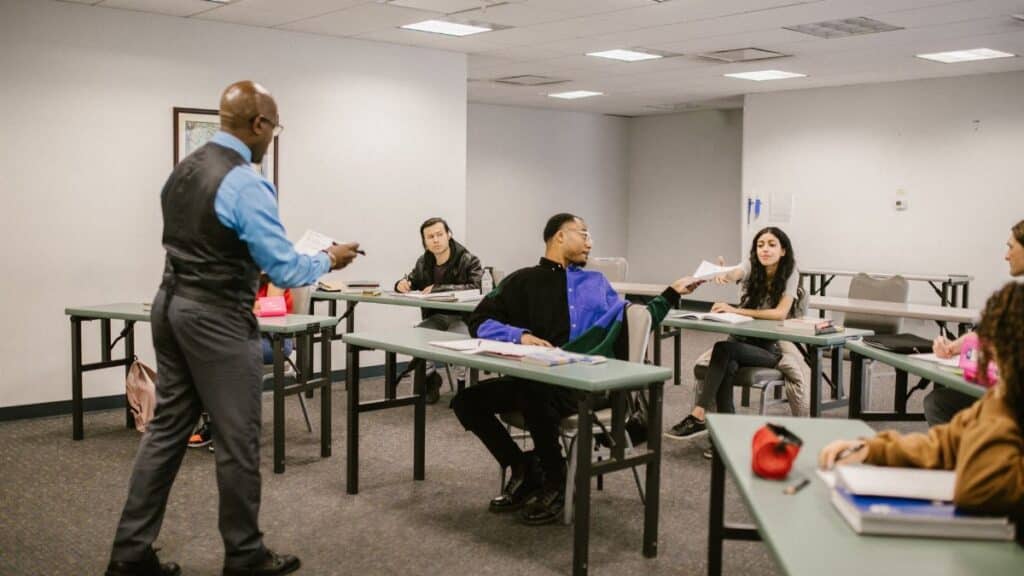 University classroom with students receiving instructions from a professor.