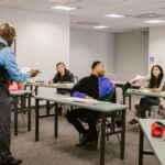 University classroom with students receiving instructions from a professor.