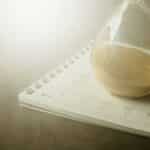 An hourglass on a calendar captures the essence of time management and urgency.
