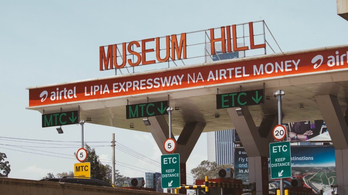 View of Museum Hill toll plaza in Nairobi, Kenya, displaying road signs and payment options.