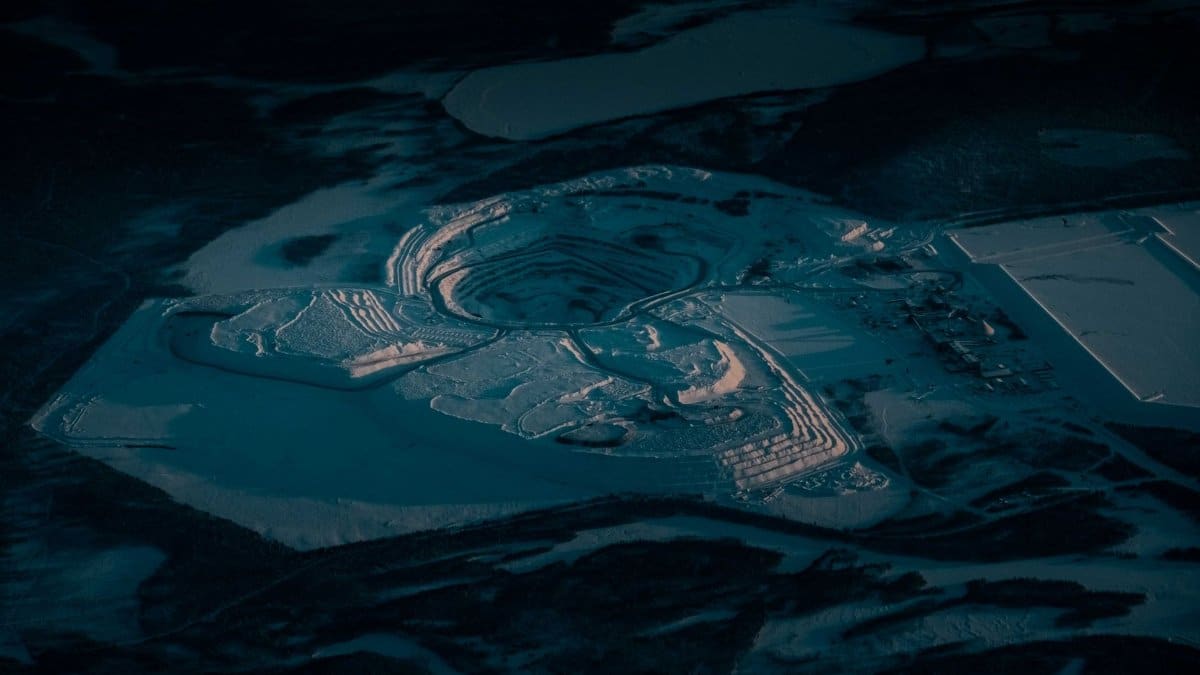 From above of sand pit with dry uneven surface and wavy traces in twilight