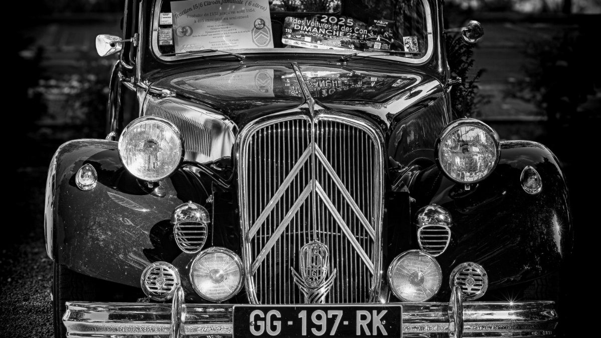 A classic Citroën car showcased in a striking black and white photograph, highlighting its vintage charm.