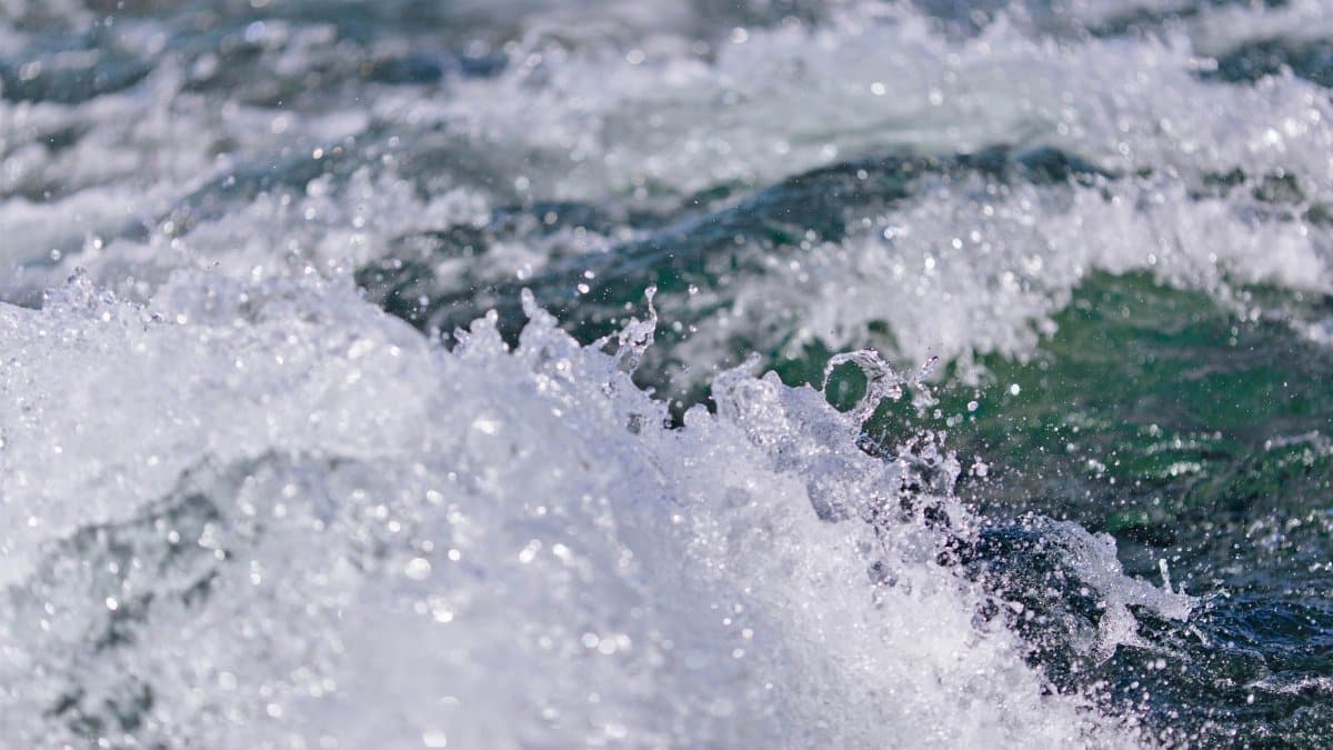 Close-up of ocean waves splashing, capturing motion and energy in the water surface.