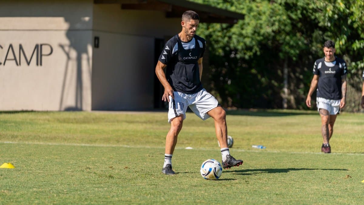 Soccer players practicing during an outdoor training session at a sports camp.