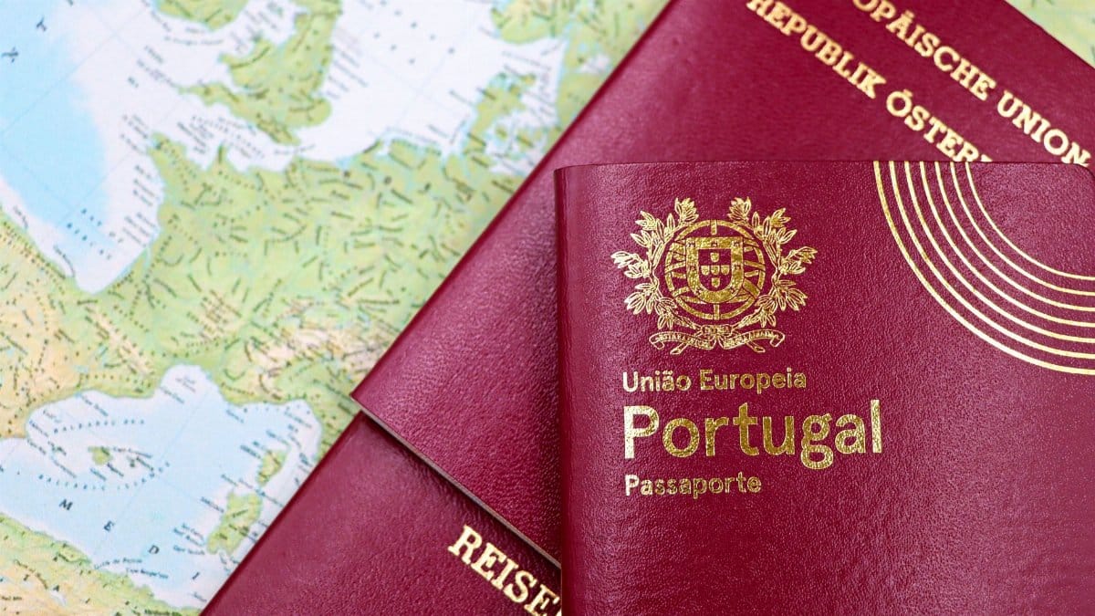 Close-up of Portuguese and Austrian passports lying on a map of Europe, symbolizing travel and mobility.