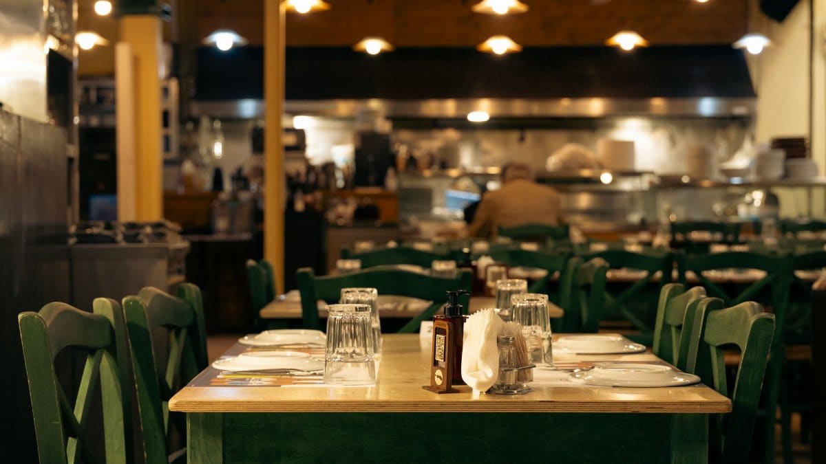 Warm and inviting Greek café interior with set dining tables in Athens, Greece.