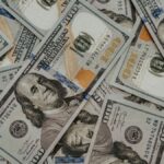 Close-up of American 100 dollar bills scattered, highlighting wealth and currency concepts.