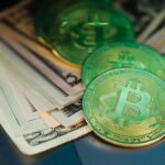 Close-up of Bitcoin with US dollars symbolizing digital and paper currency.