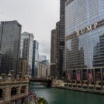 Scenic view of Chicago River with iconic skyscrapers and Trump Tower, capturing city life.