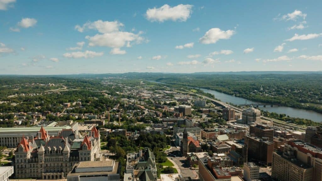 Stunning aerial shot of Albany cityscape and Hudson River on a clear day.