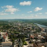 Stunning aerial shot of Albany cityscape and Hudson River on a clear day.