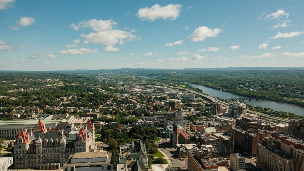 Stunning aerial shot of Albany cityscape and Hudson River on a clear day.