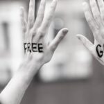 Hands raised with 'Free Gaza' message during a protest, symbolic and expressive.