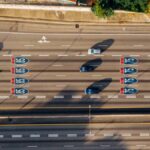 Overhead view of cars on Atlanta's I-85 and I-75 highways on a sunny day.