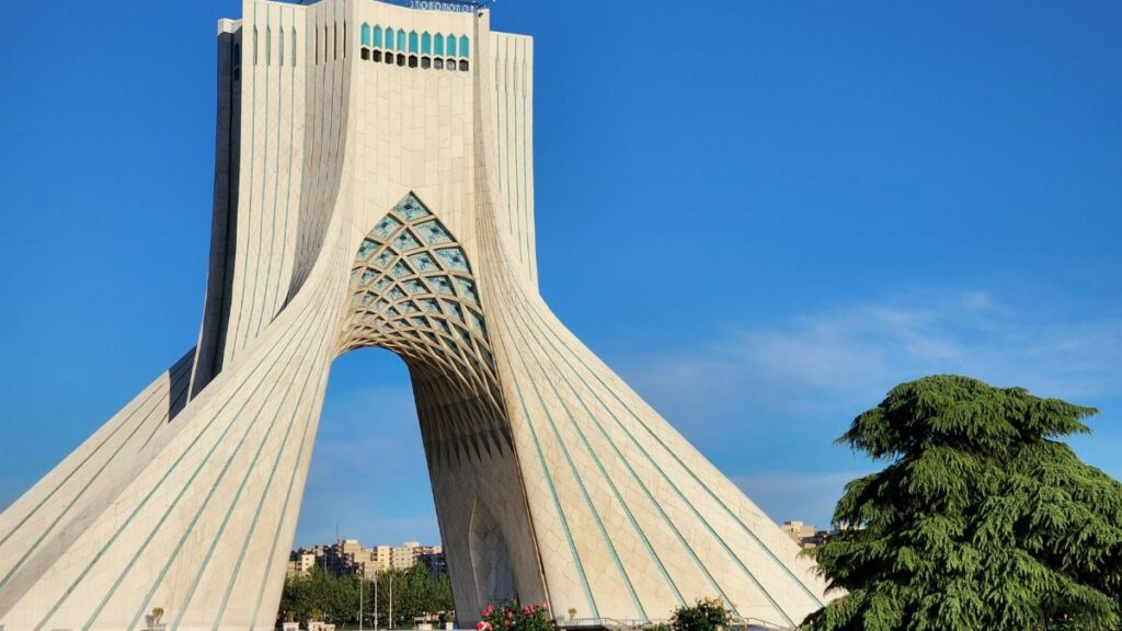 Azadi Tower, a prominent architectural landmark in Tehran, Iran, captured on a sunny day.