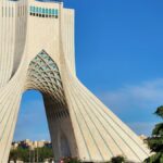 Azadi Tower, a prominent architectural landmark in Tehran, Iran, captured on a sunny day.