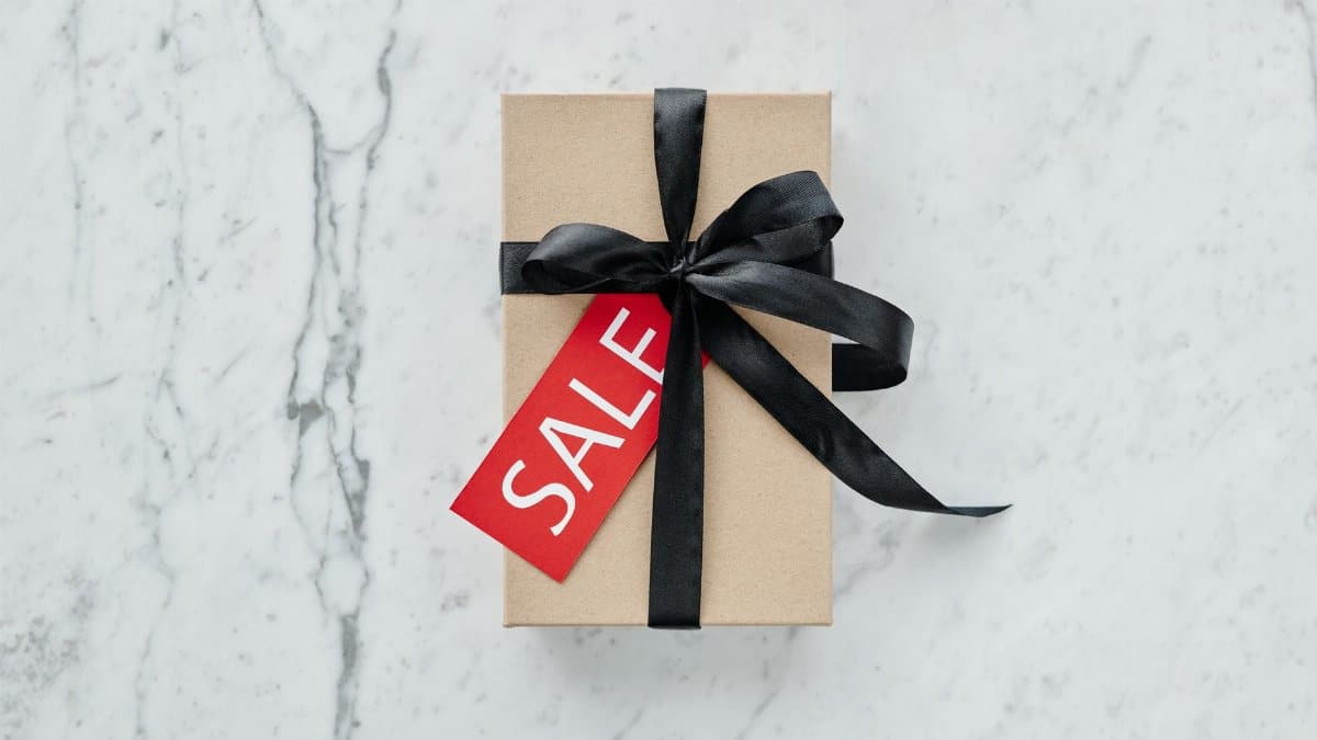 A minimalist gift box with a black ribbon and sale tag, perfect for promotions and special offers.