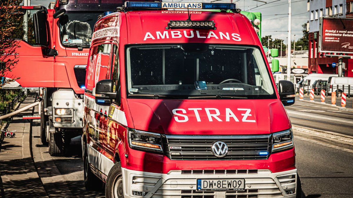 Red emergency vehicles on a sunny day in Wrocław, Poland, illustrating local services in action.