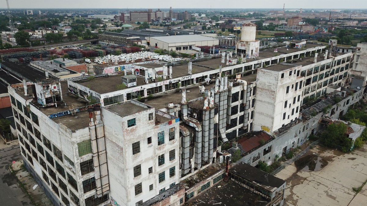 Drone shot of a large, abandoned industrial building in Detroit, Michigan.