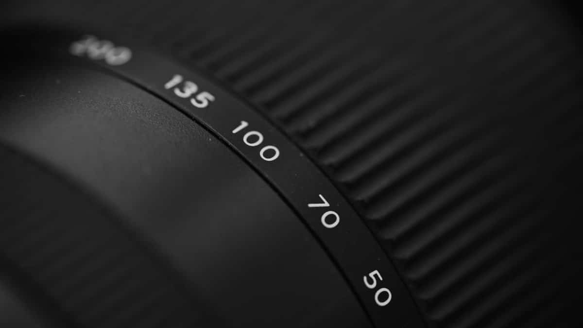 Detailed macro shot of a camera lens showing focus scale markings.