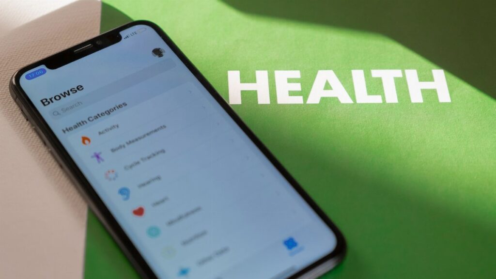 Close-up of a smartphone displaying a health app on a green surface with 'HEALTH' text.