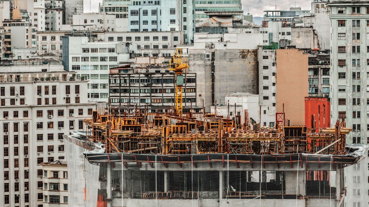 Construction site in São Paulo city with modern high-rise buildings in the background.