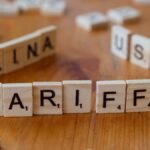Wooden letter blocks spelling tariffs, China, and USA representing trade relations.