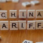 Scrabble tiles spelling 'China' and 'Tariffs' symbolize global trade issues.