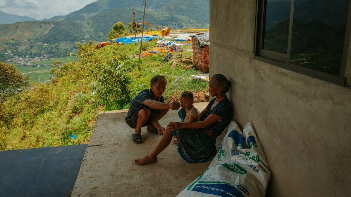 A family shares a moment on a high-altitude porch with scenic mountain views.
