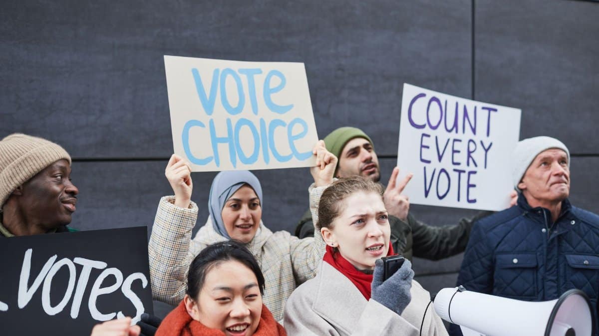A diverse group of adults hold signs demanding vote counts and choice at an outdoor protest.