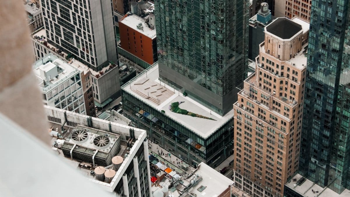 High-angle view of dense skyscrapers and rooftops in New York City, showcasing urban architecture.