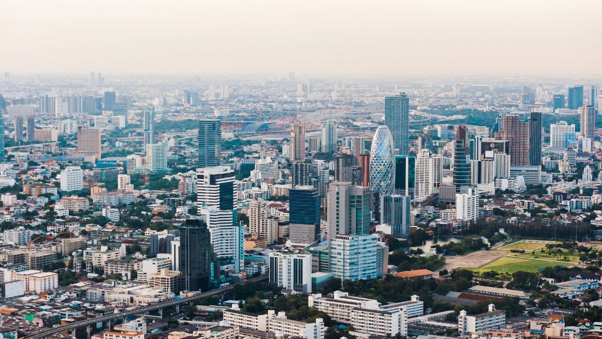 Skyline view of a sprawling urban city with towering skyscrapers and dense buildings.
