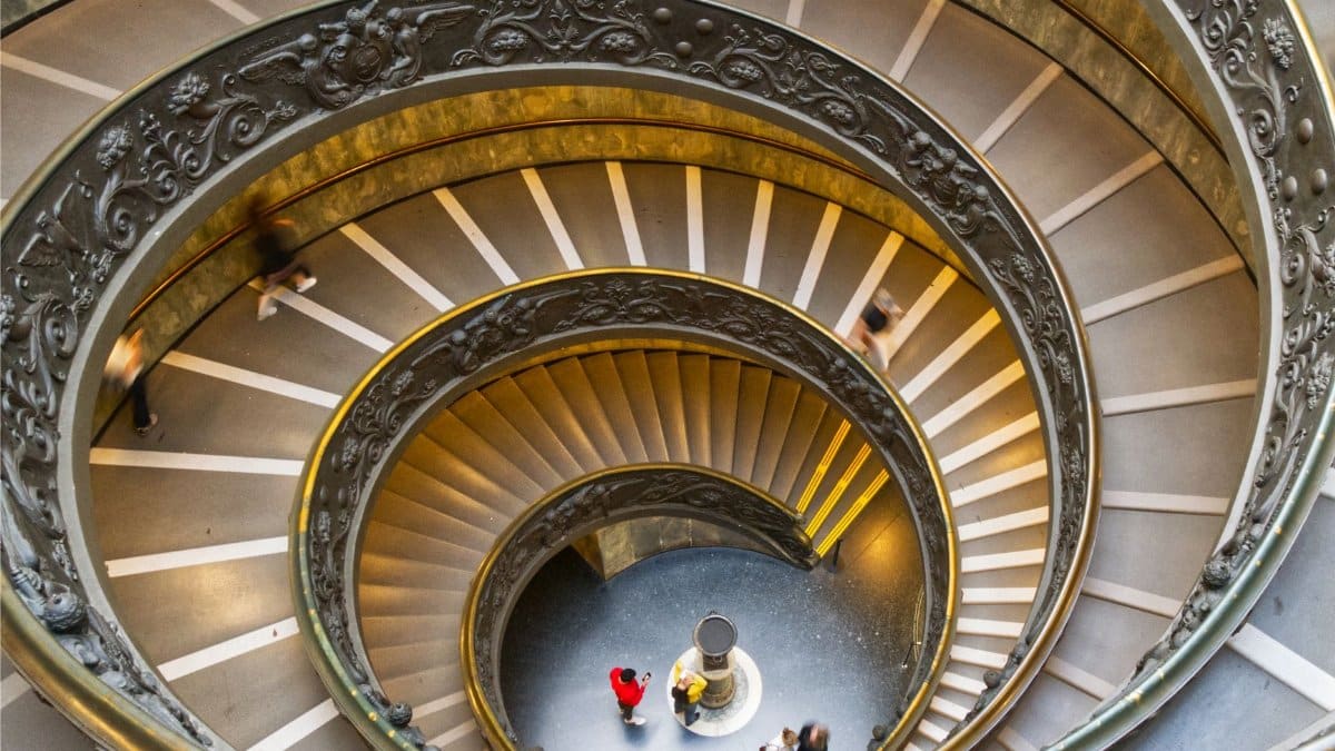 View from above of the iconic spiral staircase in Vatican Museums, capturing its intricate details.