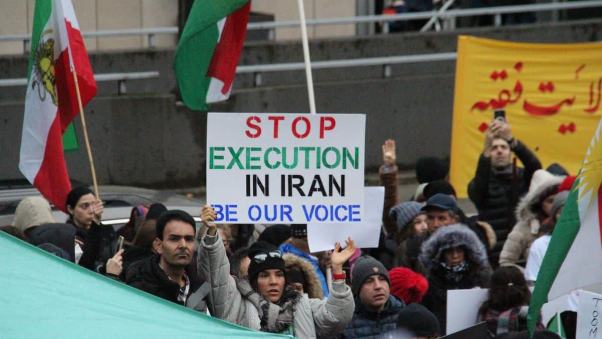 A peaceful protest in Vancouver advocating for justice in Iran with flags and placards