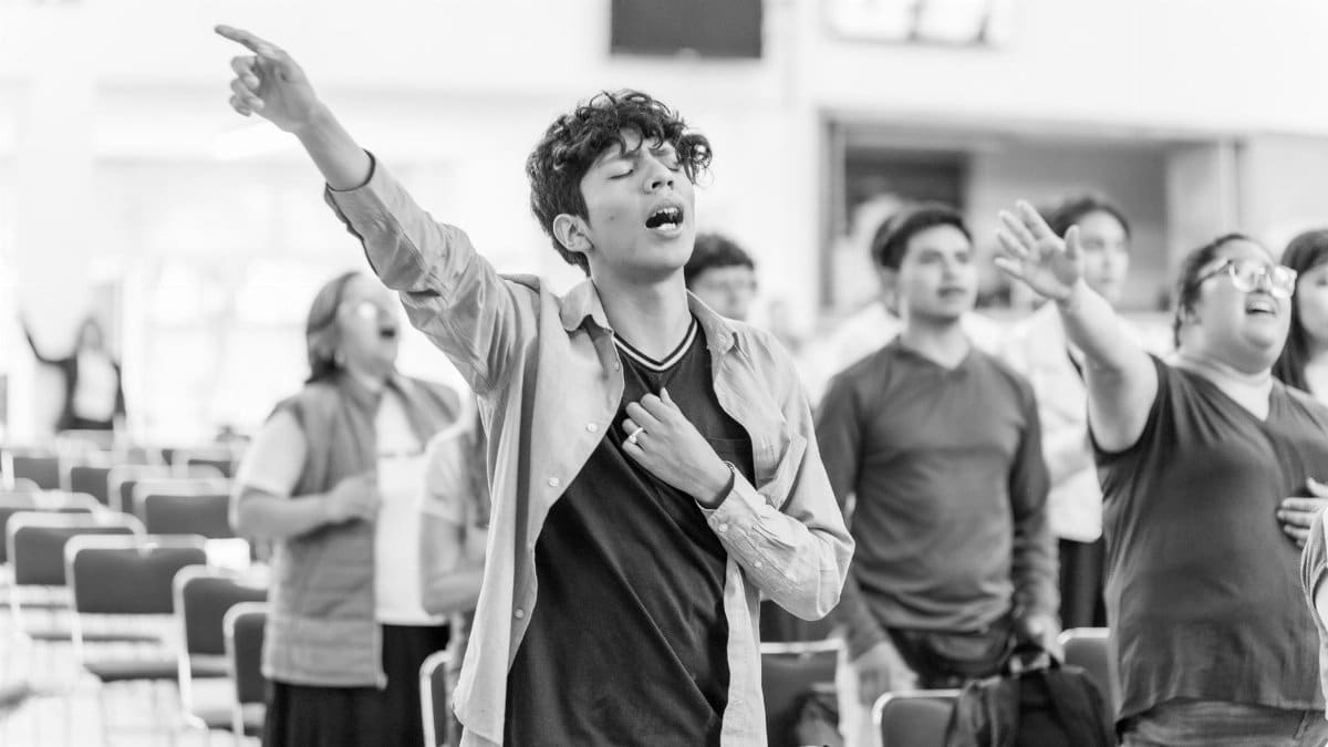 People engaged in heartfelt worship in a religious gathering in Ciudad de México.