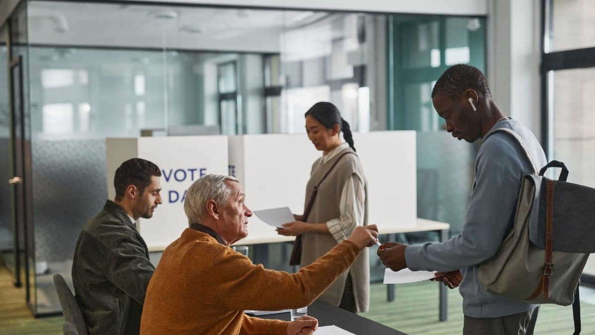 People of various backgrounds participating in voting at a polling station.