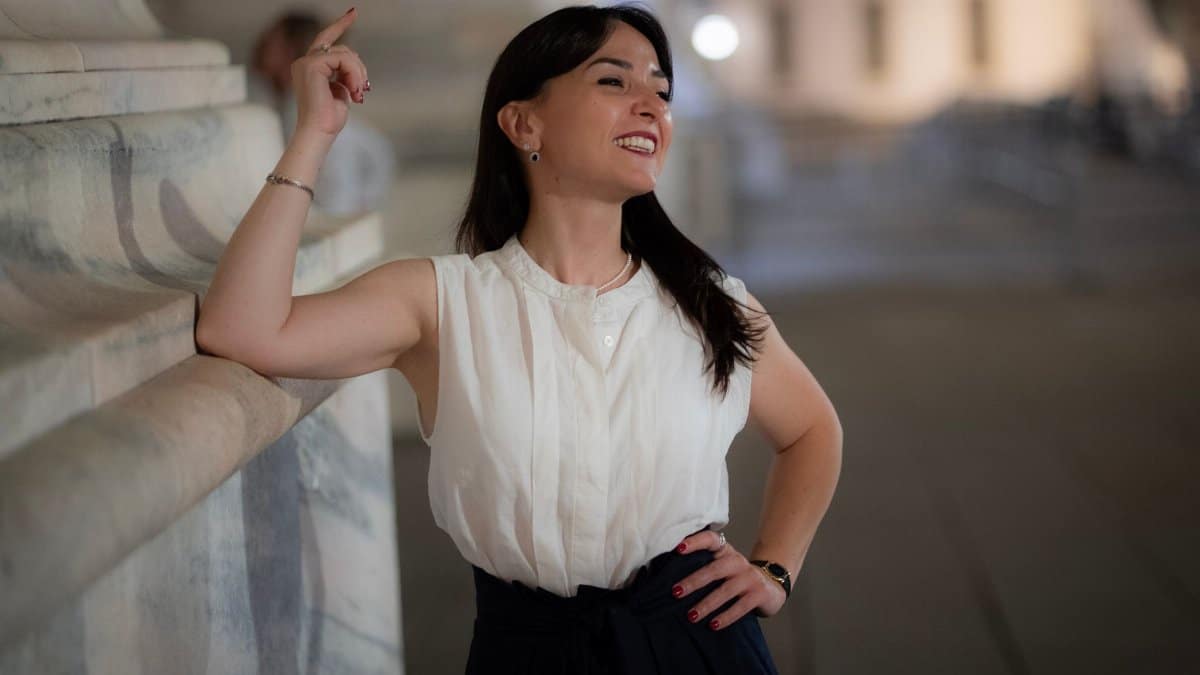 Confident woman posing in an elegant outfit on a night in Milan, Italy.