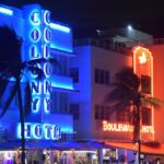 Lively neon-lit hotels illuminate the Miami Beach nightlife, highlighting Art Deco architecture.