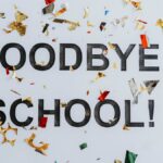 Colorful confetti surrounds a goodbye school message, celebrating graduation.