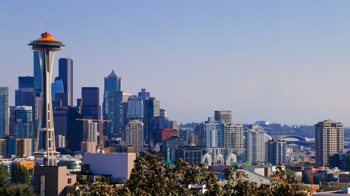 Iconic Seattle skyline featuring the Space Needle against a clear blue sky.