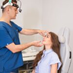 A plastic surgeon examines a patient's nose in a modern clinic setting in Istanbul.