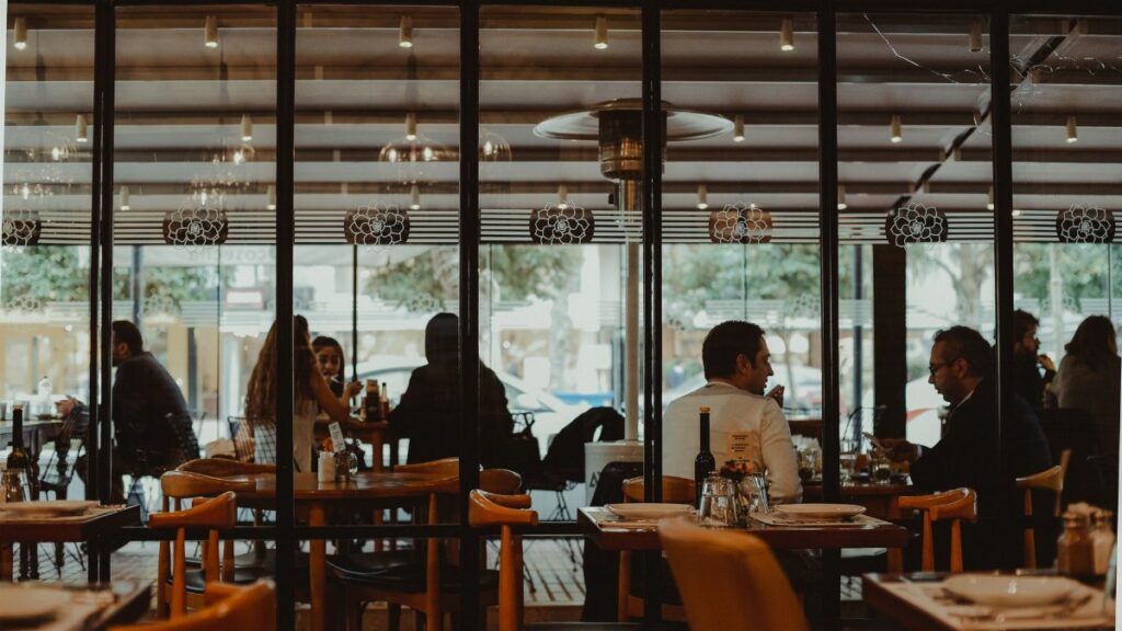 A bustling restaurant interior showcasing diners enjoying their meals in a cozy atmosphere.