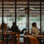 A bustling restaurant interior showcasing diners enjoying their meals in a cozy atmosphere.
