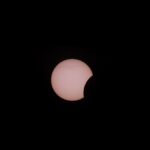 Capturing a partial solar eclipse with the moon obscuring the sun.