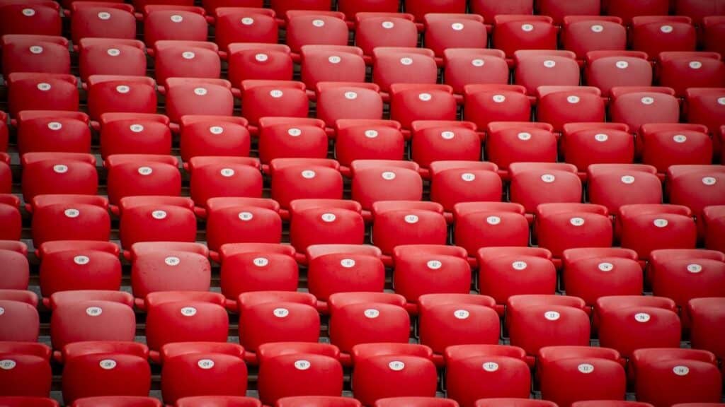 Empty red stadium seats in symmetrical arrangement at San Mames stadium in Bilbao, Spain.