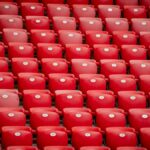 Empty red stadium seats in symmetrical arrangement at San Mames stadium in Bilbao, Spain.