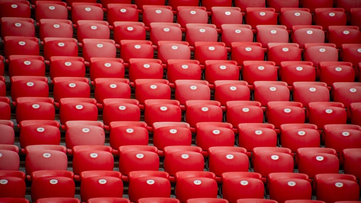 Empty red stadium seats in symmetrical arrangement at San Mames stadium in Bilbao, Spain.